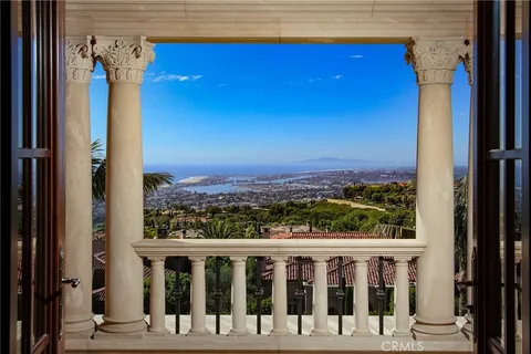 a view of a balcony with wooden floor and fence