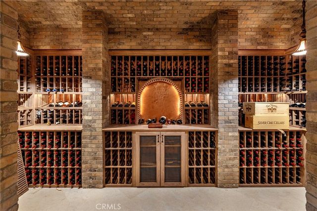 a view of swimming pool with seating area and trees in the background