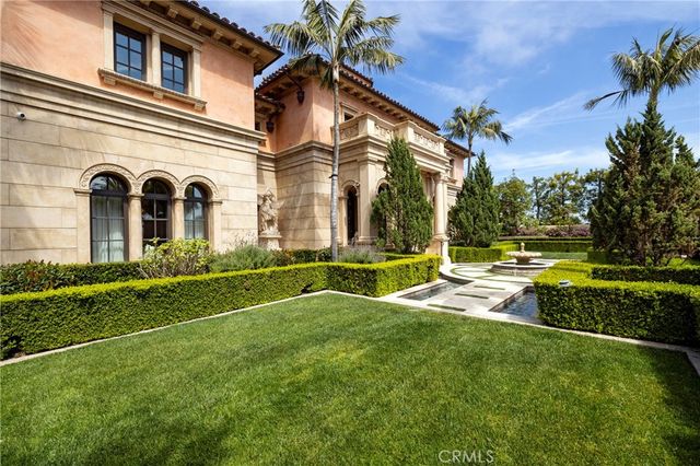 a front view of a house with yard and green space