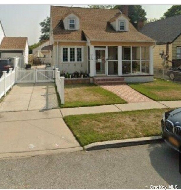 a view of a house with cars park