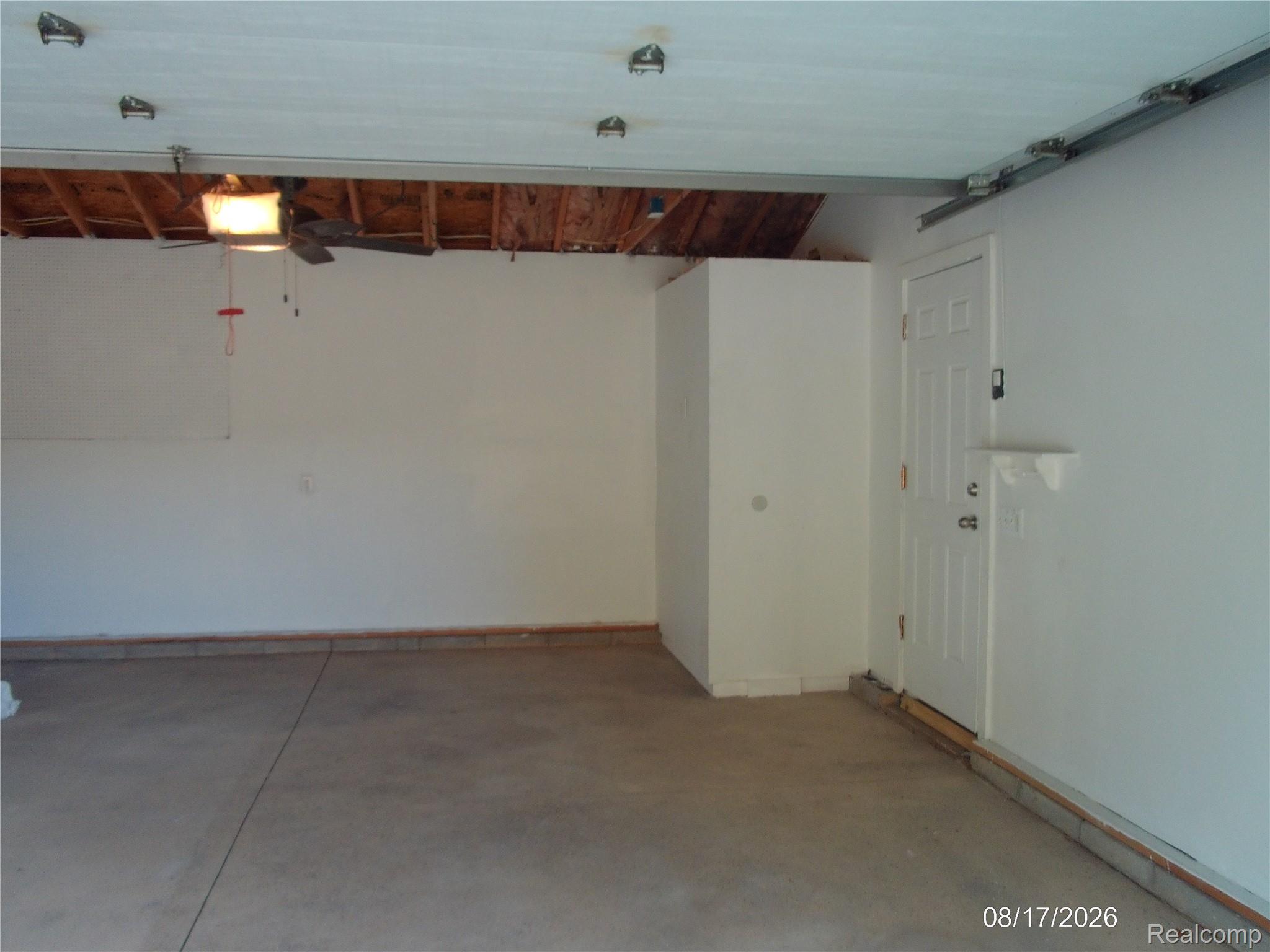 26445 Colgate Street Inkster, MI 48141 - Photo 27 of 35 Garage with concrete flooring, interior access door, built-in storage cabinet, and ceiling fan