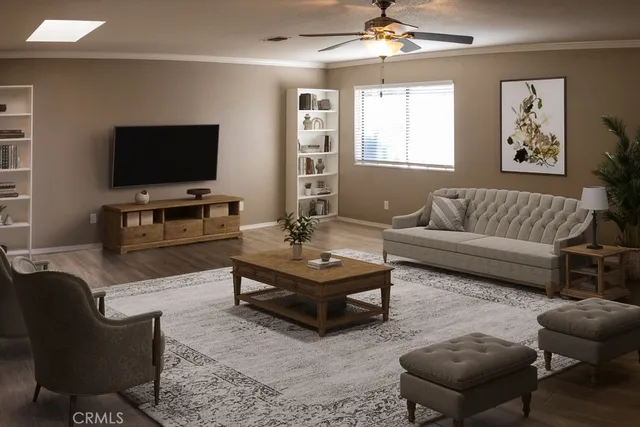 a living room with furniture a flat screen tv and a window