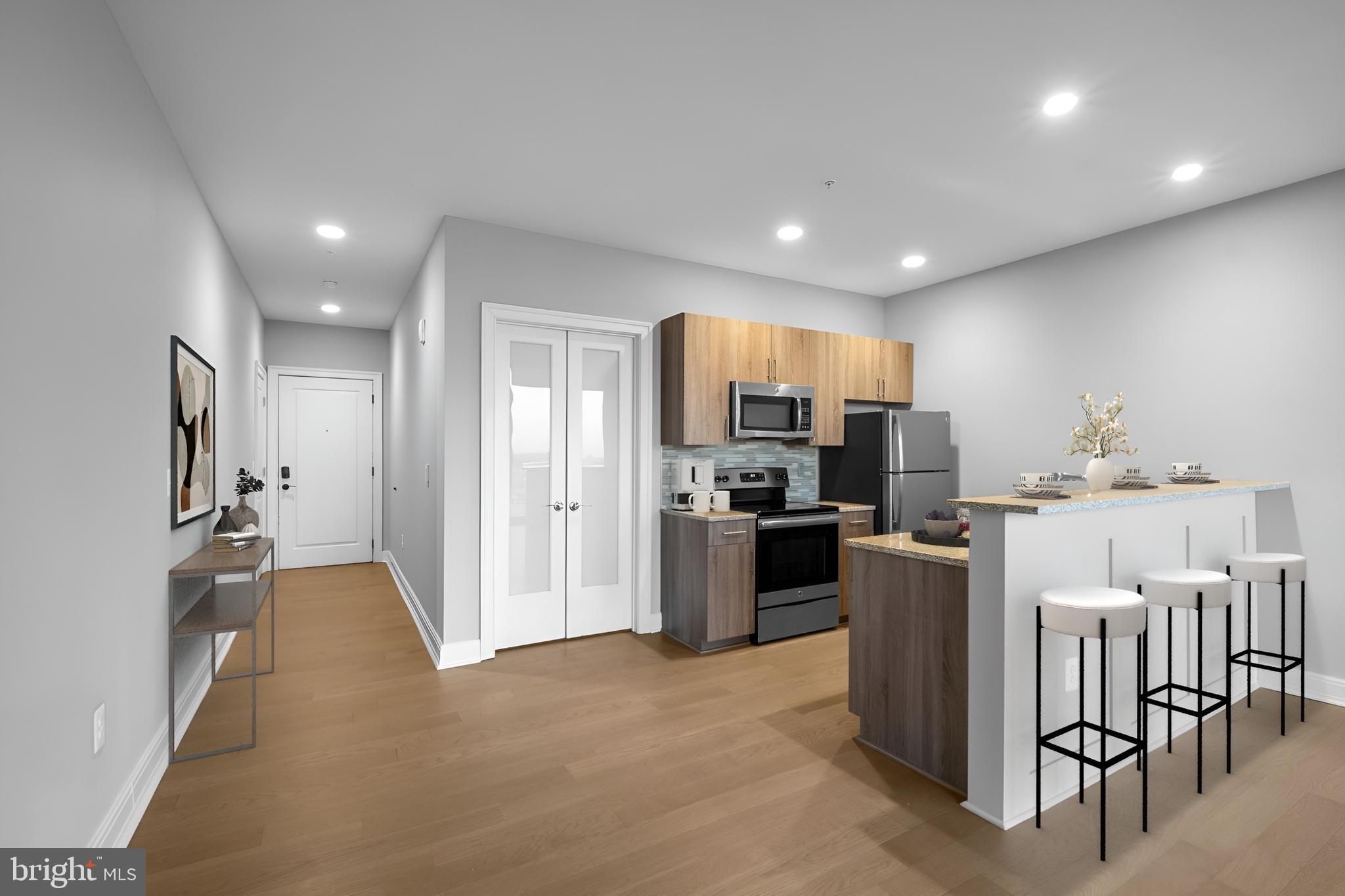 200 North 16th Street, Unit 701 Philadelphia, PA 19102 - Photo 1 of 82 a kitchen with stainless steel appliances kitchen island granite countertop a refrigerator and a stove top oven