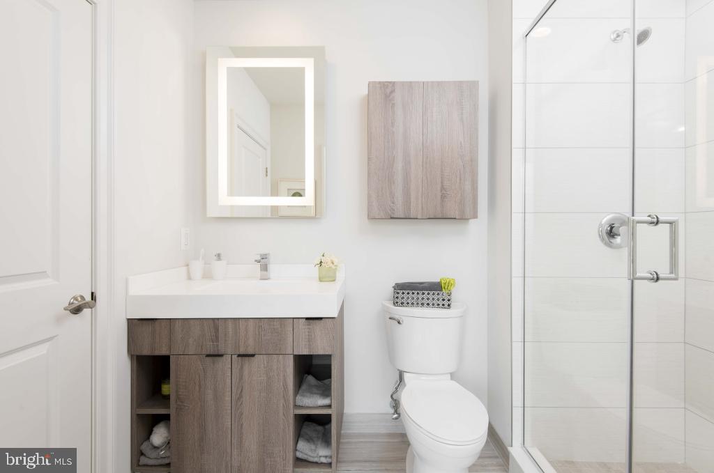 200 North 16th Street, Unit 701 Philadelphia, PA 19102 - Photo 82 of 82 a bathroom with a toilet a sink and mirror