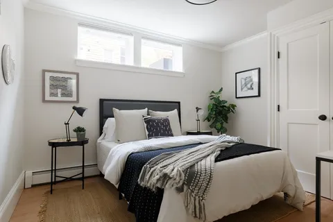 a bedroom with bed and a window