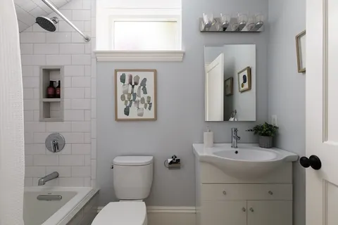 a bathroom with a toilet sink and shower