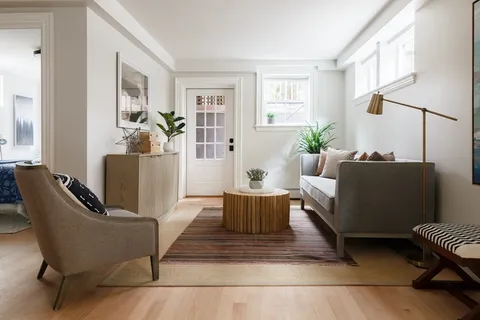 a living room with furniture rug and window