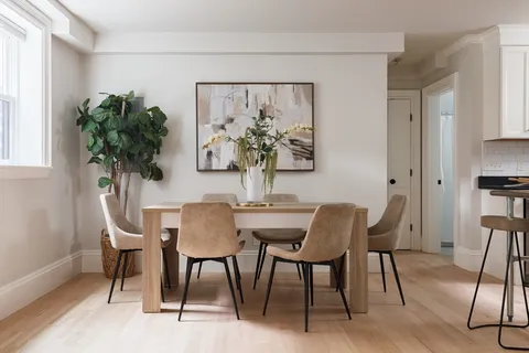 a view of a dining room with furniture window and wooden floor
