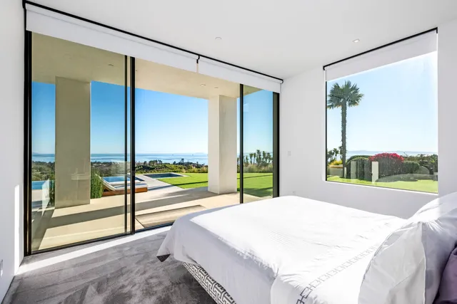 a bathroom with a tub and a large window