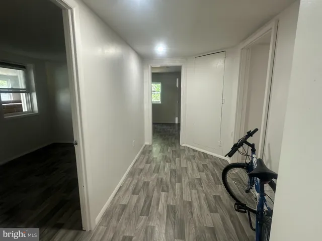 a view of a hallway with wooden floor and stairs