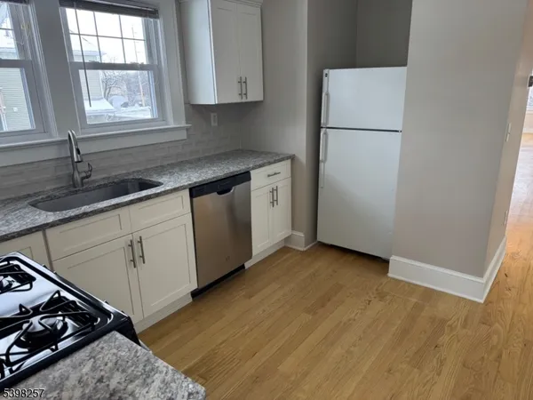 a kitchen with sink cabinets and window