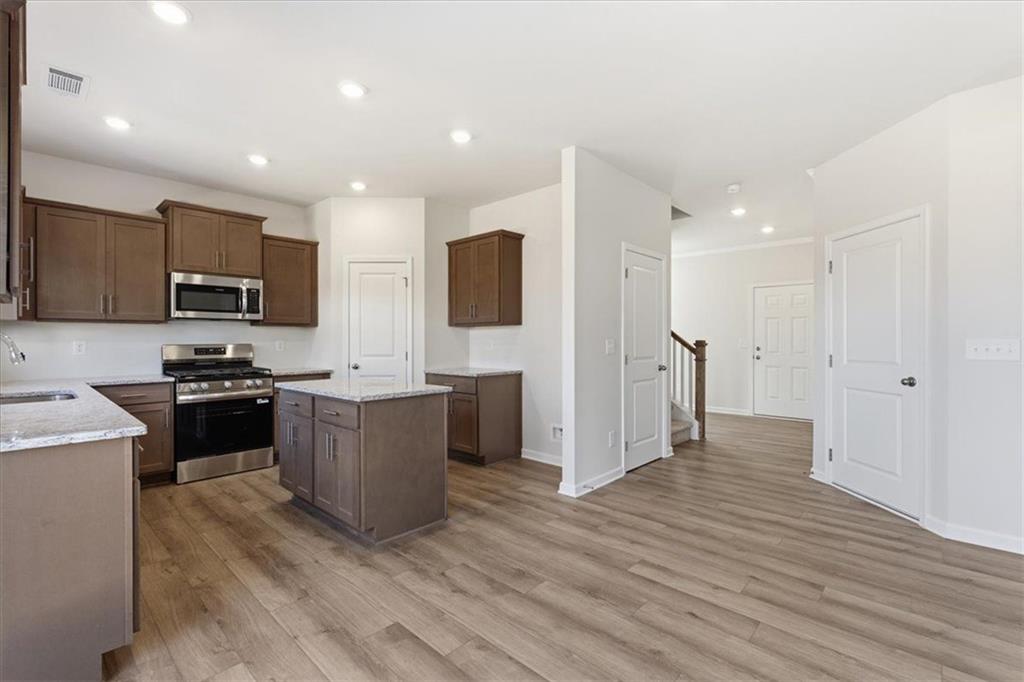 129 Bloomfield Circle Canton, GA 30114 - Photo 11 of 36 a large kitchen with stainless steel appliances granite countertop a stove a sink and a refrigerator