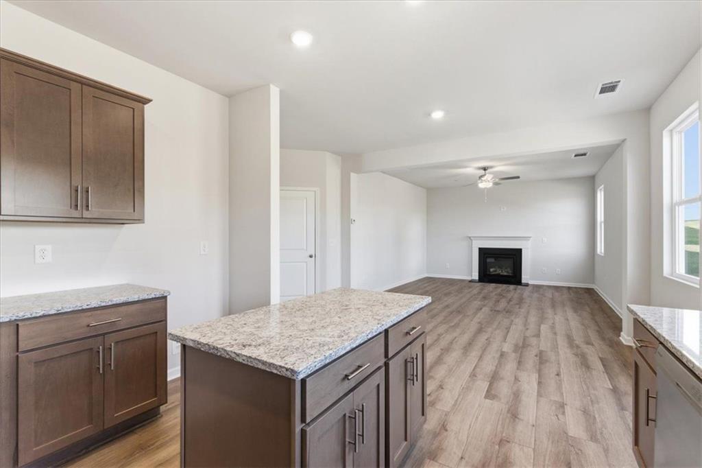 129 Bloomfield Circle Canton, GA 30114 - Photo 15 of 36 a kitchen with a sink dishwasher a stove and a refrigerator with wooden floor