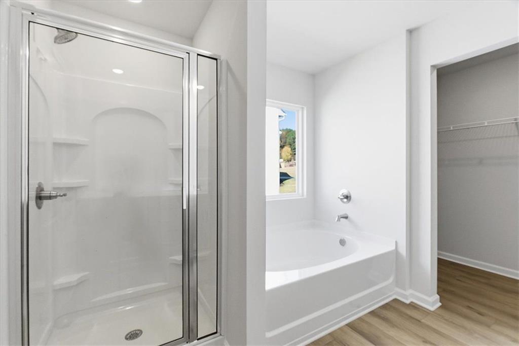 129 Bloomfield Circle Canton, GA 30114 - Photo 19 of 36 a bathroom with a bathtub and a shower