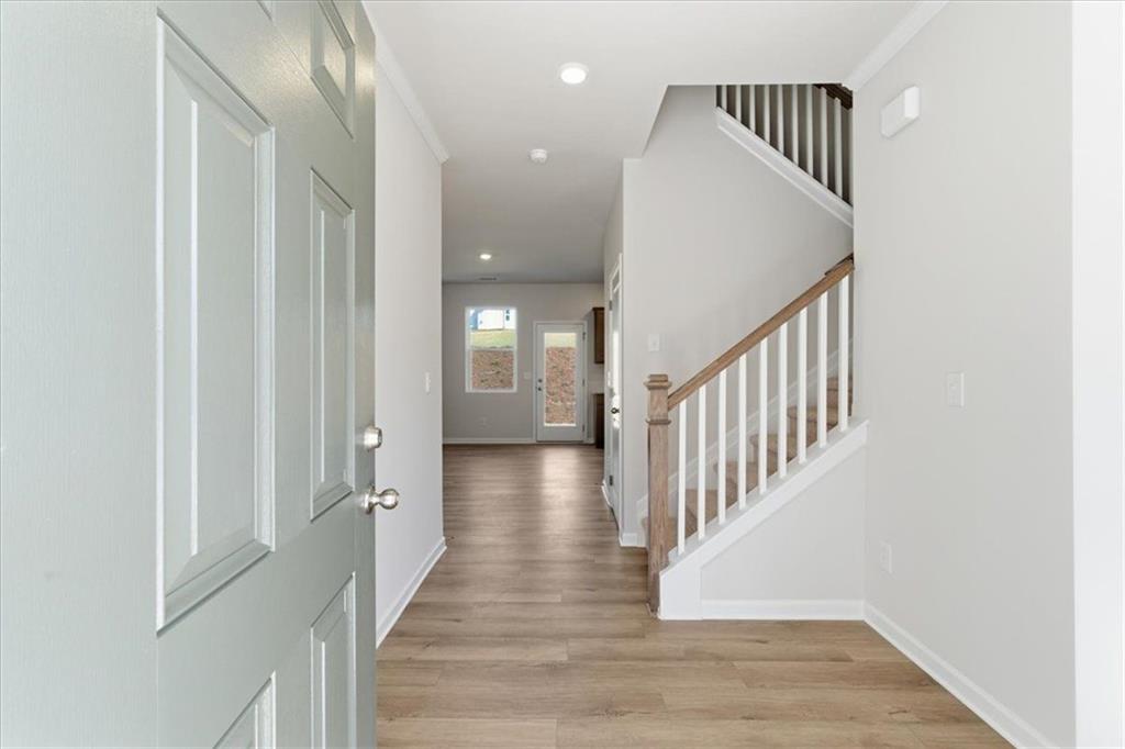 129 Bloomfield Circle Canton, GA 30114 - Photo 5 of 36 a view of a hallway with the wooden floor and staircase