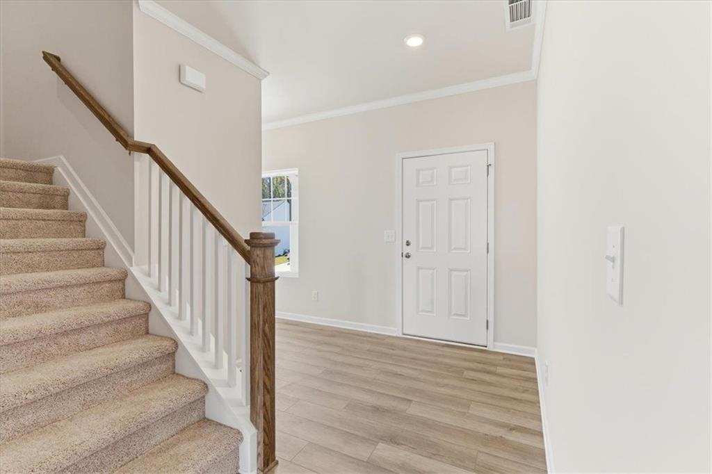 129 Bloomfield Circle Canton, GA 30114 - Photo 6 of 36 a view of staircase with wooden floor and white walls