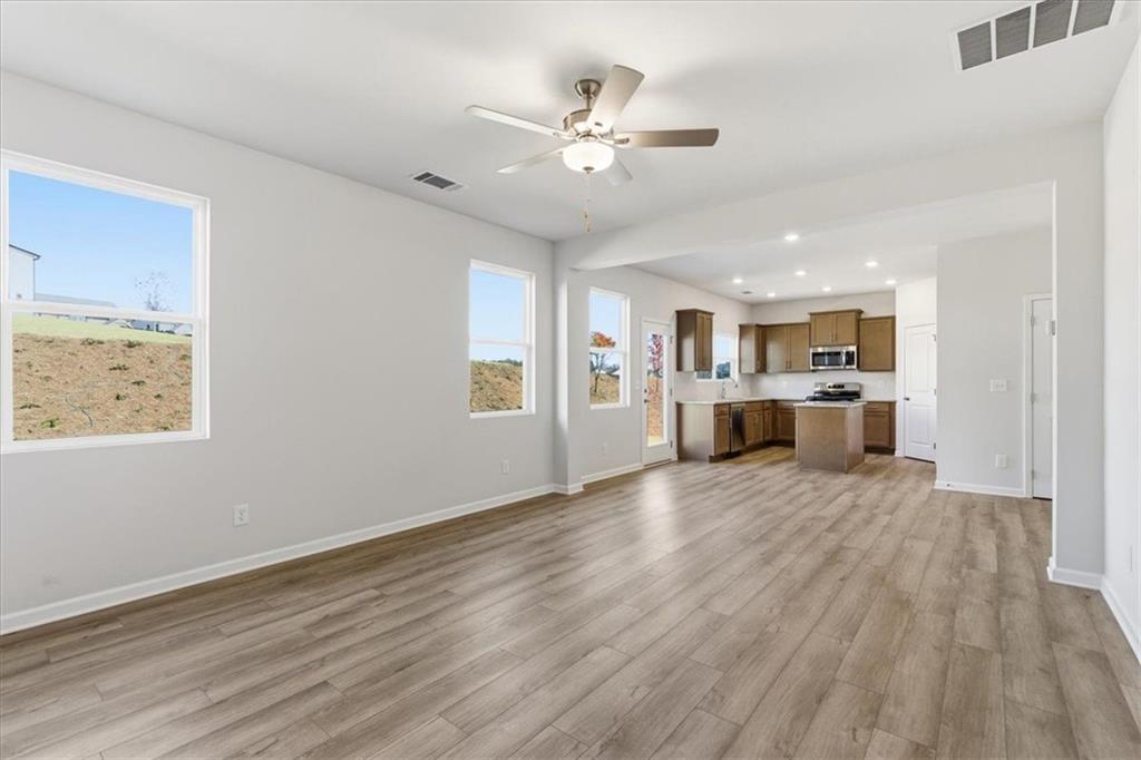 129 Bloomfield Circle Canton, GA 30114 - Photo 9 of 36 a view of an empty room with a window and wooden floor
