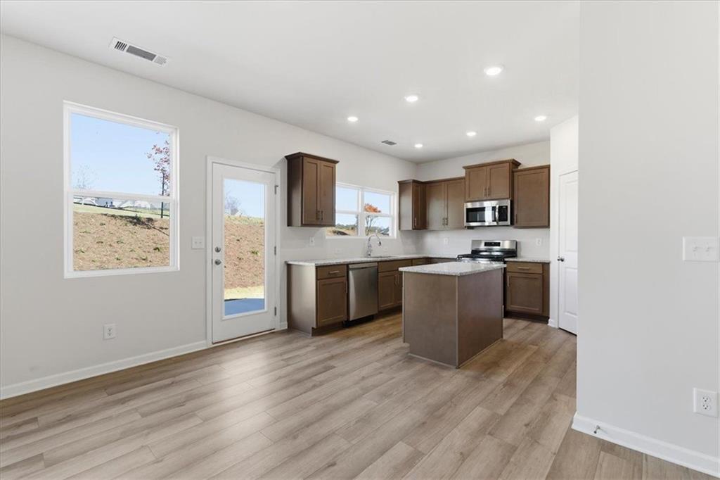 129 Bloomfield Circle Canton, GA 30114 - Photo 10 of 36 a kitchen with a sink cabinets and wooden floor