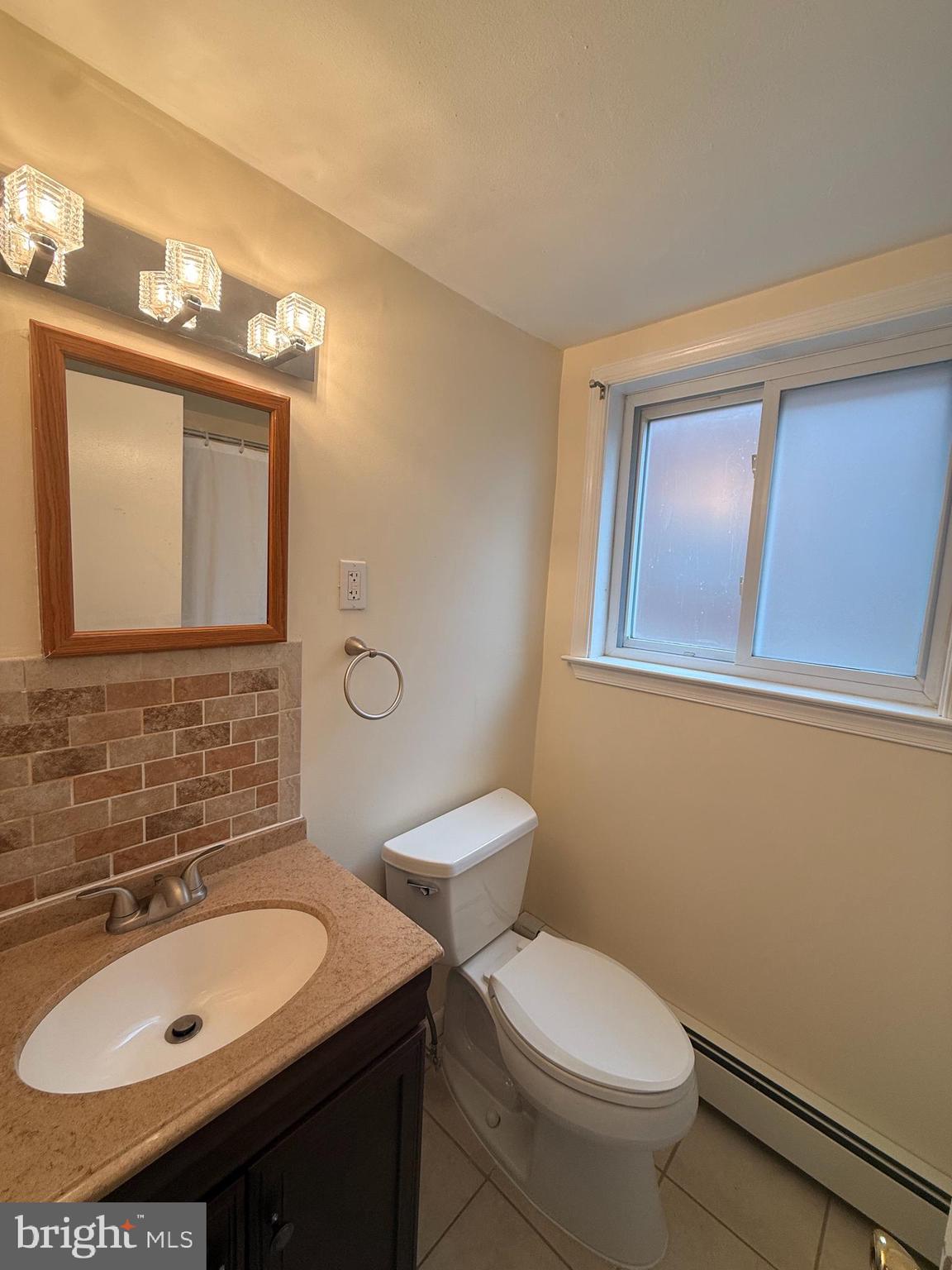 216 Boro Road, Unit A Secane, PA 19018 - Photo 19 of 26 a bathroom with a sink toilet and mirror