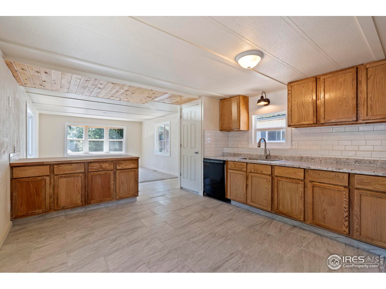400 South Overland Trail, Unit 6 Fort Collins, CO 80521 - Photo 11 of 21 a kitchen with a sink cabinets and wooden floor
