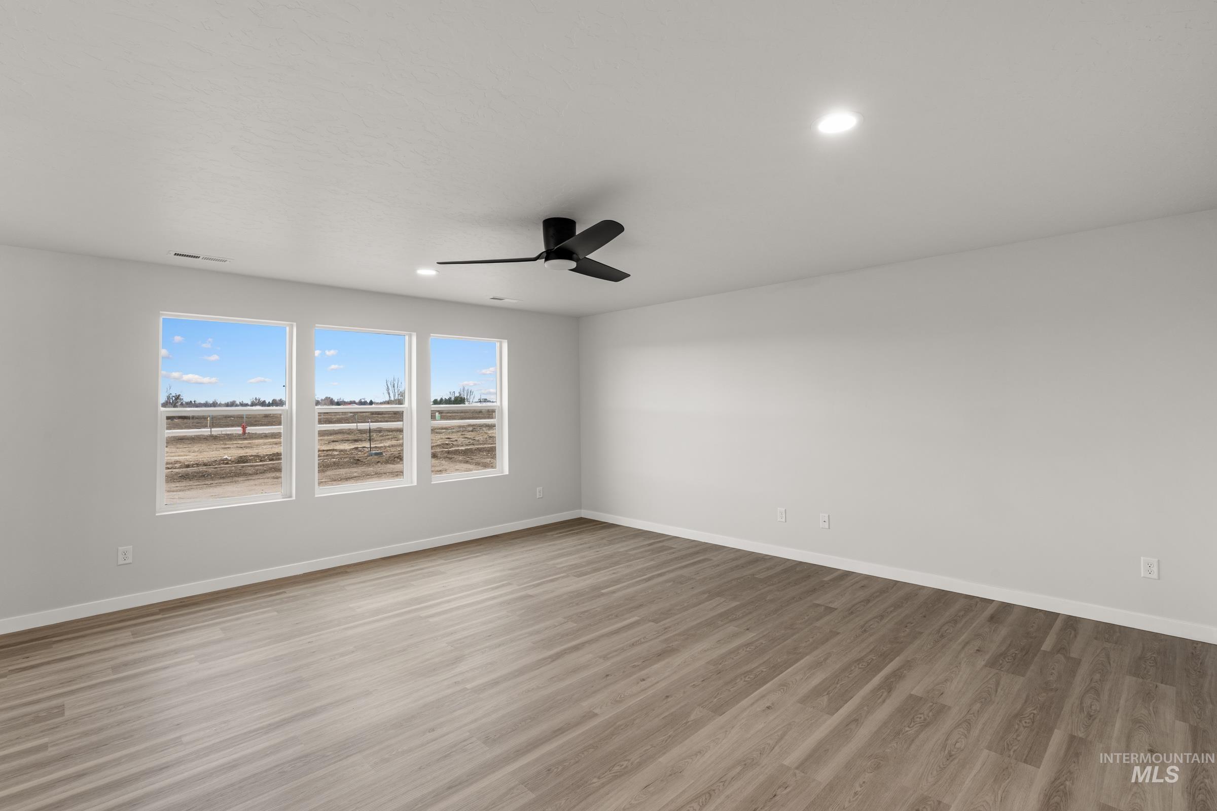 13693 Redway Court Caldwell, ID 83607 - Photo 7 of 25 Spare room featuring a ceiling fan, light wood-style flooring, and recessed lighting