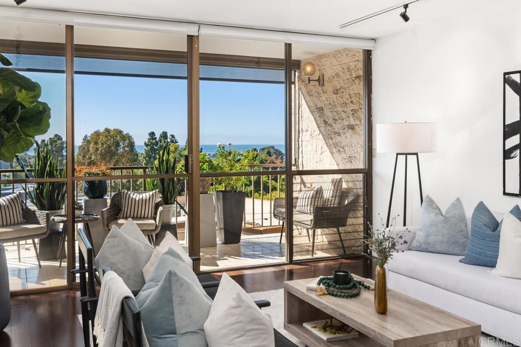 a living room with furniture and a floor to ceiling window