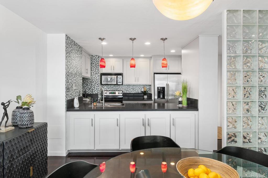 2500 Torrey Pines Road, Unit 402 La Jolla, CA 92037 - Photo 15 of 50 a living room with stainless steel appliances kitchen island granite countertop a sink and a microwave