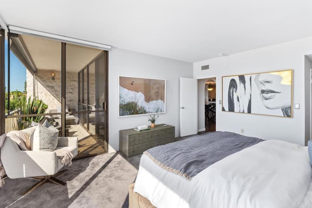 2500 Torrey Pines Road, Unit 402 La Jolla, CA 92037 - Photo 19 of 50 a spacious bedroom with a bed a couch and a large window