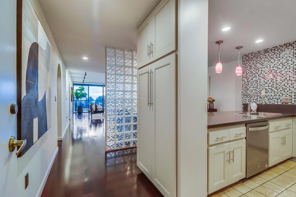 2500 Torrey Pines Road, Unit 402 La Jolla, CA 92037 - Photo 30 of 50 a kitchen with cabinets and wooden floor
