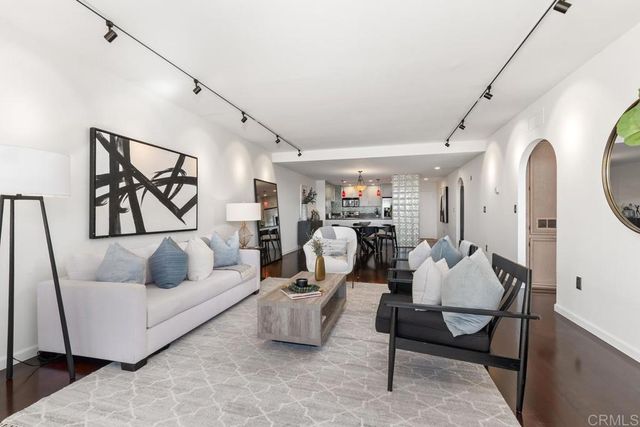 a living room with furniture and white walls