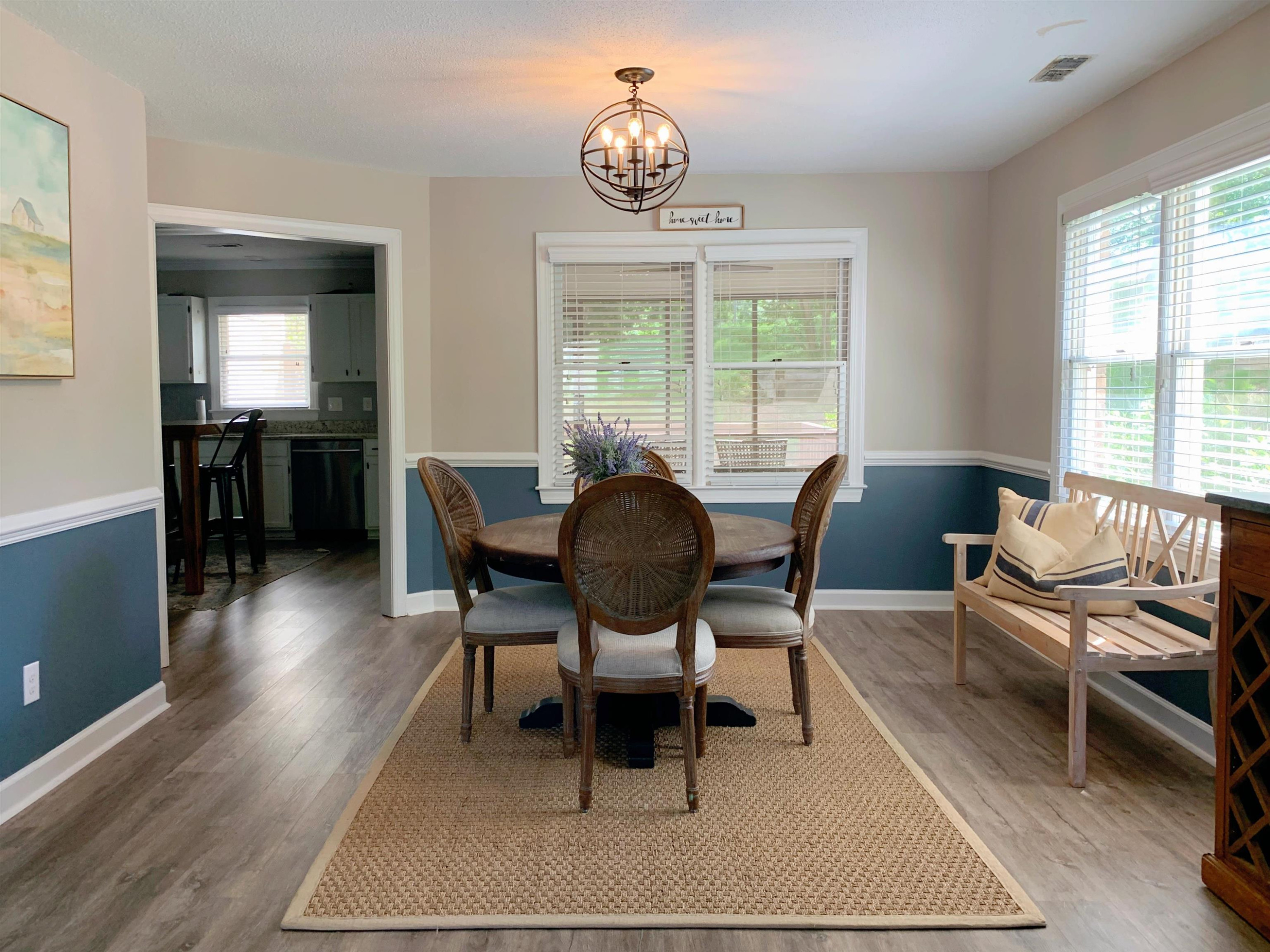 4100 Settlement Drive Durham, NC 27713 - Photo 4 of 5 a living room with furniture a table and large windows