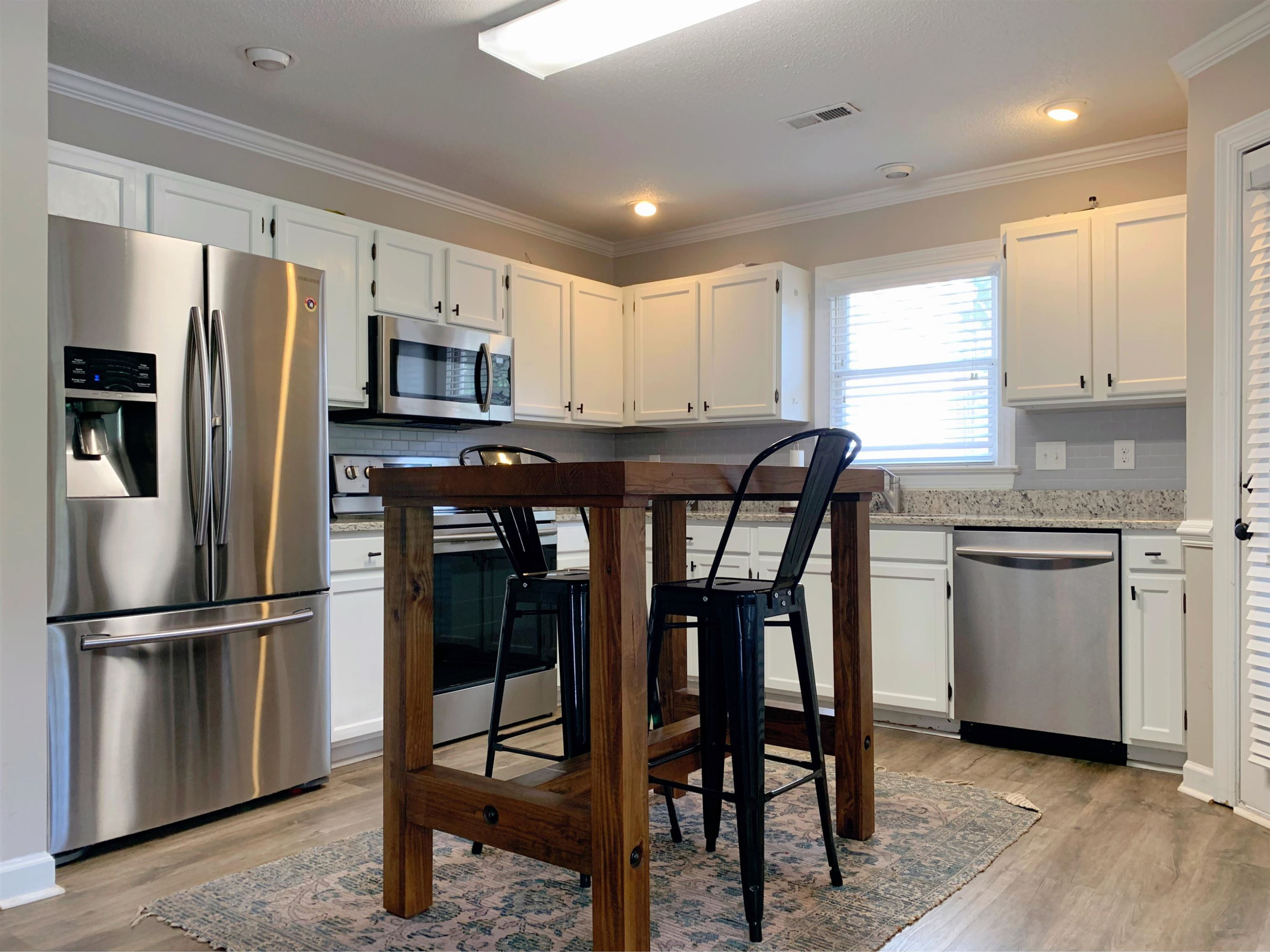 4100 Settlement Drive Durham, NC 27713 - Photo 5 of 5 a kitchen with stainless steel appliances a refrigerator stove microwave and sink