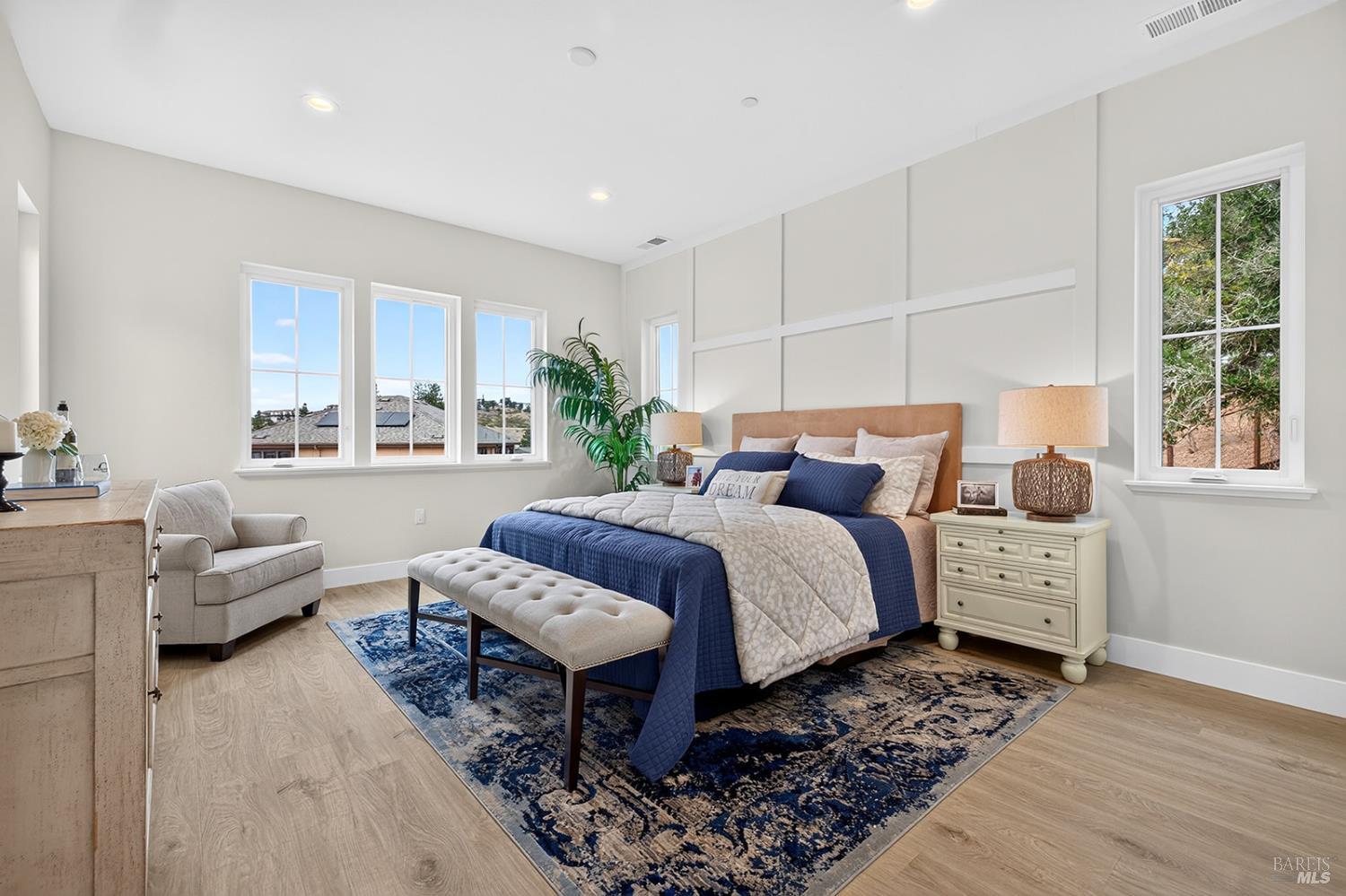 1925 Carlile Place Santa Rosa, CA 95403 - Photo 53 of 70 Here is the Primary Suite of this home. This space offers the wood flooring that is throughout this home, an accent wall, an abundance of windows to bring the sunshine in and so much more!