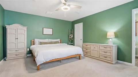 a bedroom with a bed and a dresser