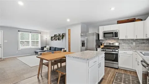 a kitchen with a stove a sink and a refrigerator