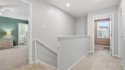 a view of hallway with livingroom and furniture