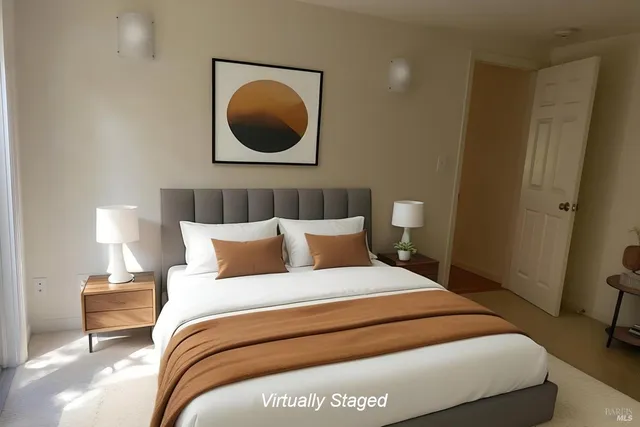 a bedroom with a bed and a painting on the wall