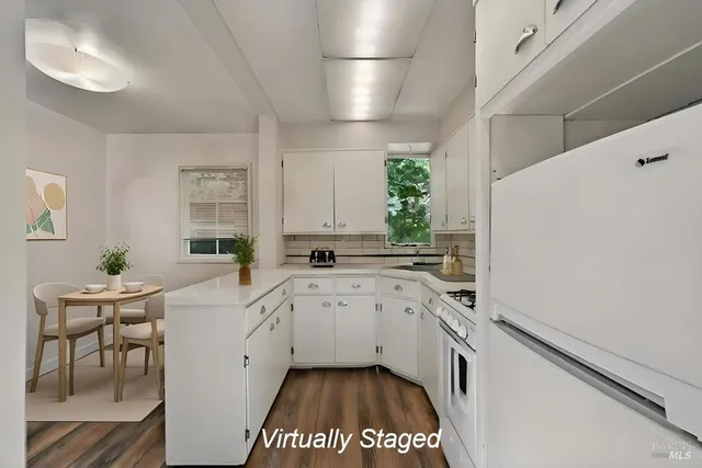 a kitchen with a sink cabinets and window