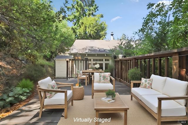 a view of a patio with couches table and chairs and potted plants
