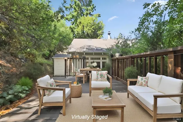 a view of a patio with couches table and chairs and potted plants