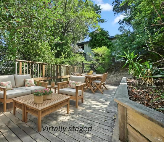 a view of a couches and lounge chairs in the balcony
