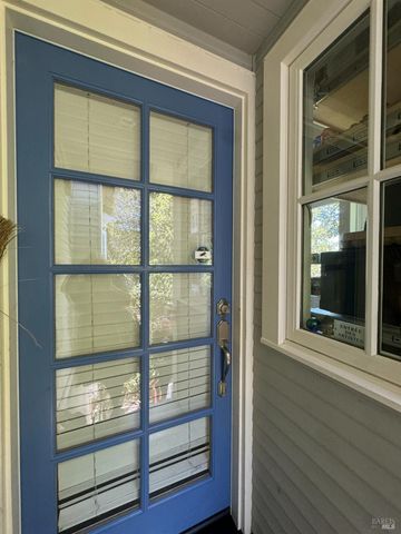 a view of wooden door and a window