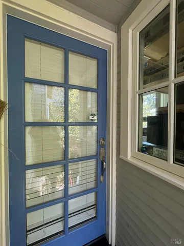 a view of wooden door and a window