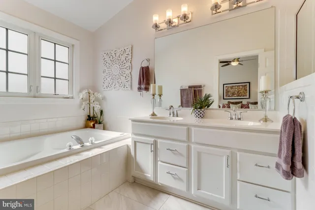 a bath tub sitting in a bathroom next to a window