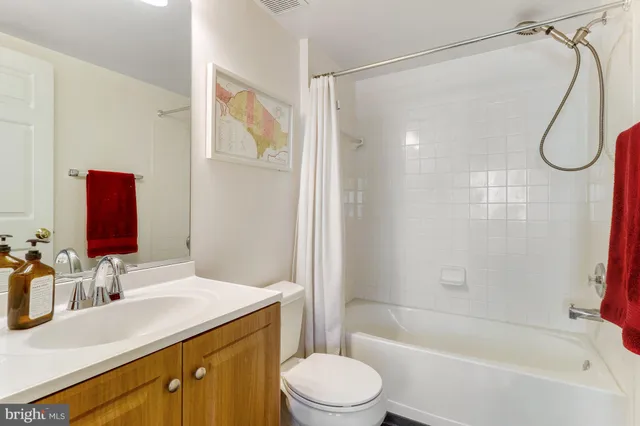 a kitchen with stainless steel appliances granite countertop a refrigerator a oven a stove and a dining table with wooden floor