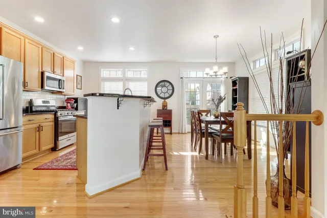 a view of a dining room with furniture wooden floor and chandelier