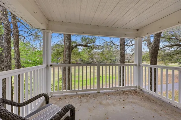 a view of a balcony with furniture