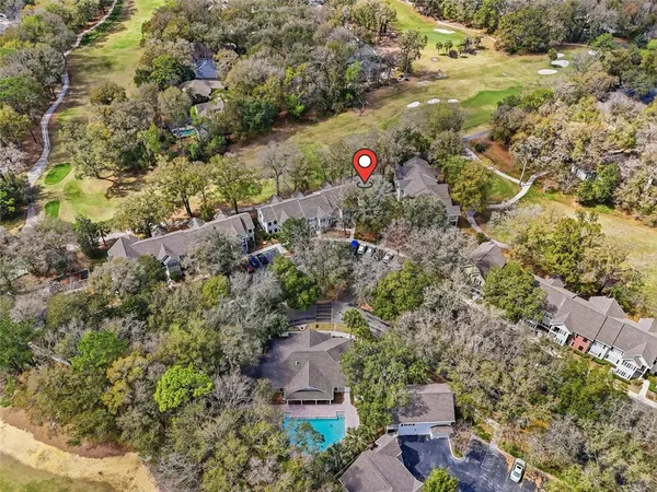 an aerial view of a house with a yard