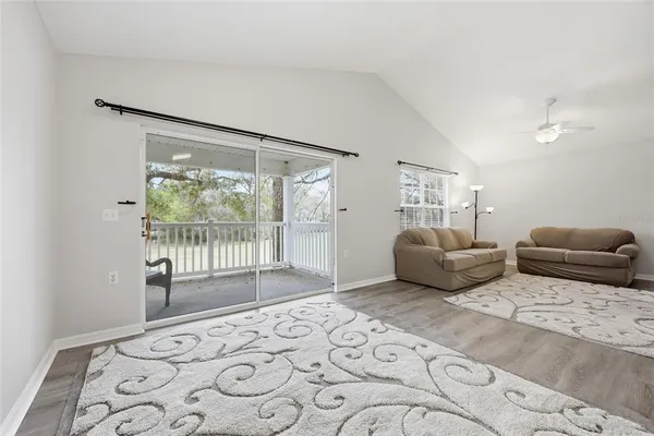 a bedroom with furniture and a large window
