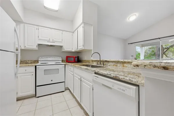a kitchen with appliances cabinets and a sink